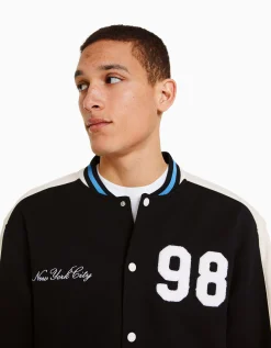 BERSHKA Cazadora efecto ante parche Negro Store